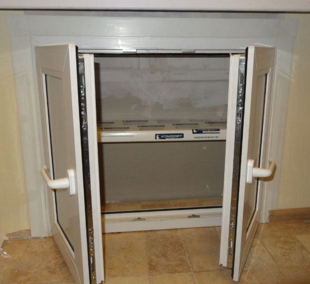 mini fridge under the window in a niche